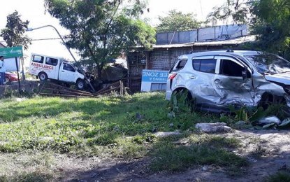 <p><strong>STILL AT COLLISION SITE</strong>. The damaged Chevrolet Trailblazer (right) and an ambulance of the Municipality of San Miguel, Iloilo Province are still at the crash site in Barangay Hibao-an Norte, Mandurriao, Iloilo City on Thursday (March 22, 2018). <em>(Photo courtesy of RMN Iloilo) </em></p>